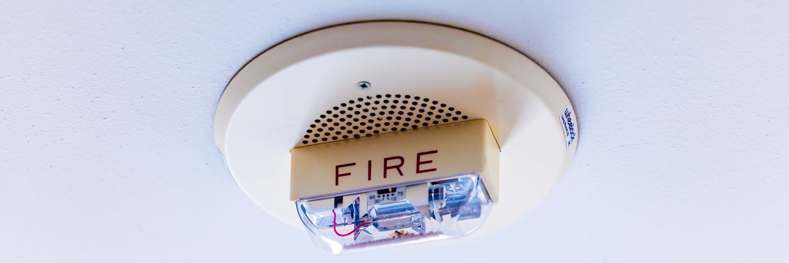A ceiling mounted fire detector in a commercial building