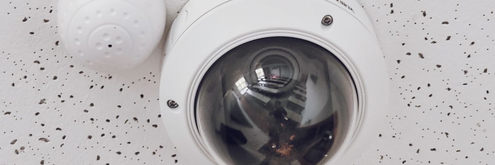 A dome surveillance camera mounted in a ceiling